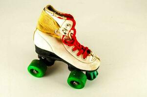 a roller skate with green wheels photo