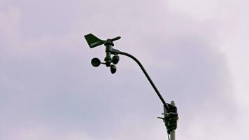 Weather vane and wind gauge for direct and strength. Stormy clouds in the backgeound. video