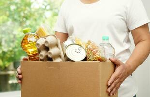 Foodstuffs in donation box for volunteer to help people. photo