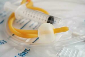 Foley catheter and urine drainage bag collect urine for disability or patient in hospital. photo