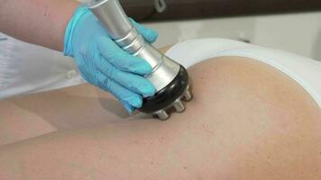 Cropped shot of a beautician doing rf lifting procedure on a female client video