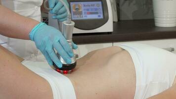 Cropped shot of a female client receiving rflifting treatment on her stomach video