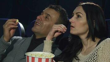 Close up of a mature couple watching a movie together at the cinema video