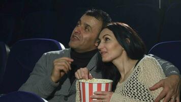 maduro feliz casal desfrutando seus encontro às a cinema assistindo uma filme video