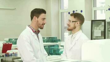 Two colleagues of laboratory assistants communicate during a break at work video