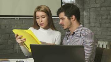 Business people working together using laptop at the office video