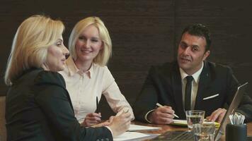 Three business partners discuss their new working project video