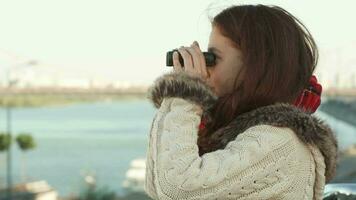 Curious girl is looking through binoculars video