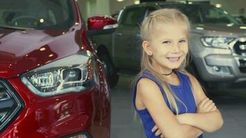 A sweet girl stands on the background of the car and laughs video
