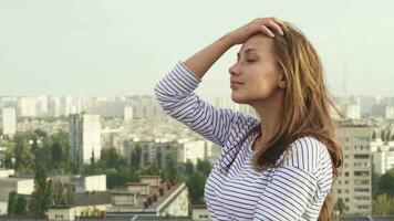 A beautiful girl enjoys seeing from the roof to the city video