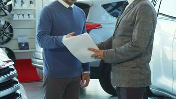 Business people discuss the details of the contract and shake hands video