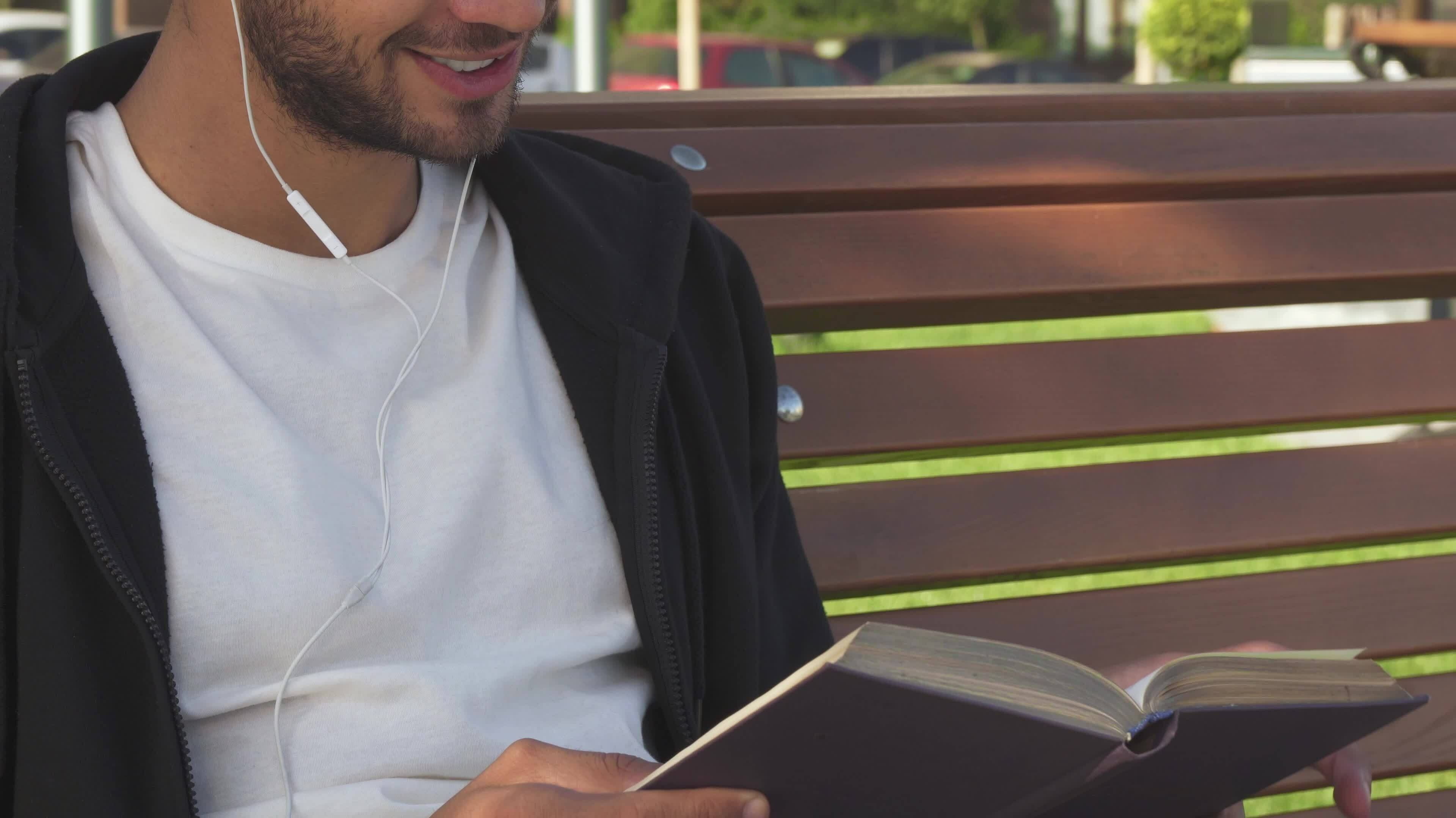 The handsome man turns over the pages and reads the book 35290572 Stock