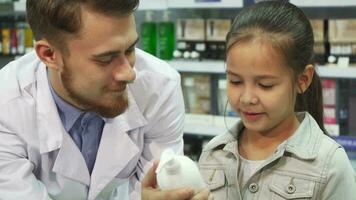 A young customer chooses which item to buy with the help of an apothecary video