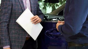 The happy buyer receives the keys to his new car video