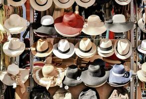 many hats are displayed on a rack photo