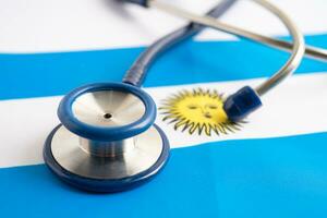 Stethoscope on Argentina flag background, Business and finance concept. photo