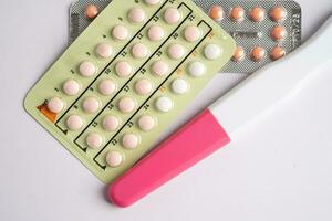 Pregnancy test and birth control pills, contraception health and medicine. photo