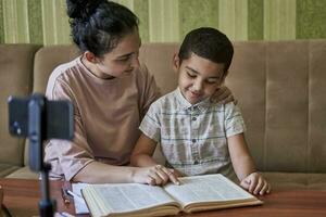 Mom tutoring son during pandemic photo