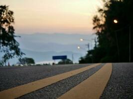 Yellow traffic line color Double solid lines to warn prohibiting overtaking, Yellow continuous tracks of prohibited overtaking painted on the asphalt, Safety driving and traffic regulating rules photo