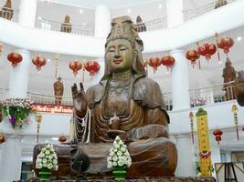 Guanyin statue in the temple, Big White Bodhisattva Guanyin statue magnificent work of art that exudes a sense of peace and tranquility, Guan Yin in Thailand temple photo