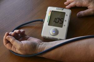 Measurement of blood pressure in a pensioner. A blood pressure monitor for humans. Treatment of a pensioner. photo