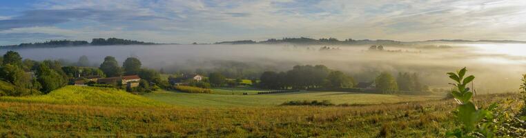 View on a farm and surrounding fields during sunrise on the pilgrimage hike Camino Santiago photo