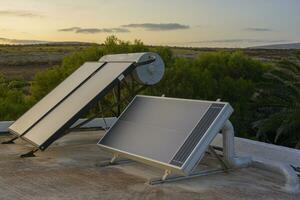 Solar warm water heating system installed on a residential rooftop photo