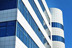 Modern office building in the city with windows and  steel and aluminum panels wall. Contemporary commercial architecture, vertical converging geometric lines. photo