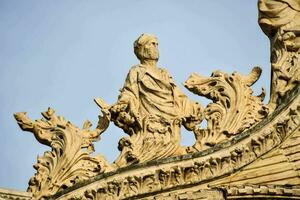 the statue of a person on the roof of the cathedral photo