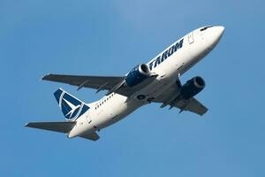 TAROM passenger plane at airport. Schedule flight travel. Aviation and aircraft. Air transport. Global international transportation. Fly and flying. photo