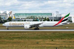 Emirates Airlines Boeing 777-300ER A6-ECV passenger plane departure and take off at Munich Airport photo