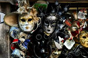 many different types of masks are displayed on a wall photo