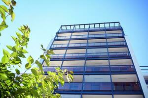 Modern apartment building in sunny day. Exterior, residential house facade. photo