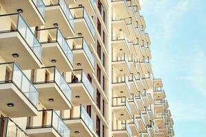 Modern apartment building in sunny day. Exterior, residential house facade. photo