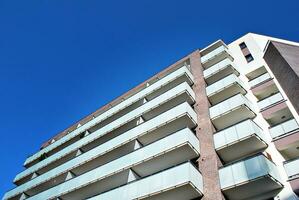 Modern apartment building in sunny day. Exterior, residential house facade. photo