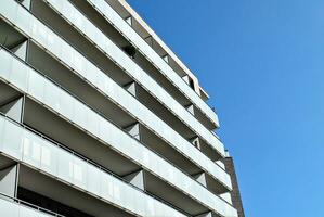 Modern apartment building in sunny day. Exterior, residential house facade. photo