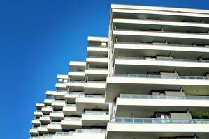 Modern apartment building in sunny day. Exterior, residential house facade. photo