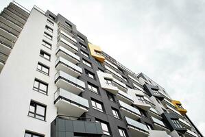 Modern apartment building in sunny day. Exterior, residential house facade. photo