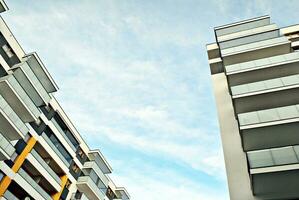 New apartment building with glass balconies. Modern architecture houses by the sea. Large glazing on the facade of the building. photo