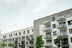 Brand new apartment building on sunny day. Modern residential architecture. Modern multi-family apartment house. photo