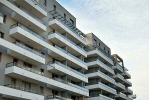 Brand new apartment building on sunny day. Modern residential architecture. Modern multi-family apartment house. photo