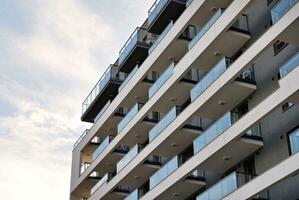 Brand new apartment building on sunny day. Modern residential architecture. Modern multi-family apartment house. photo