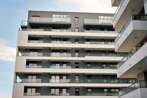 Brand new apartment building on sunny day. Modern residential architecture. Modern multi-family apartment house. photo