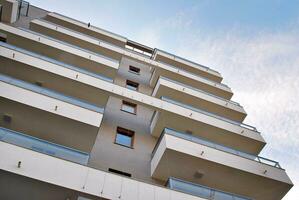 Brand new apartment building on sunny day. Modern residential architecture. Modern multi-family apartment house. photo