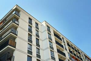 Brand new apartment building on sunny day. Modern residential architecture. Modern multi-family apartment house. photo