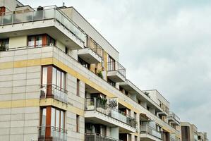 Brand new apartment building on sunny day. Modern residential architecture. Modern multi-family apartment house. photo