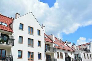 Brand new apartment building on sunny day. Modern residential architecture. Modern multi-family apartment house. photo