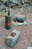 a group of old rusty barrels and a rope photo