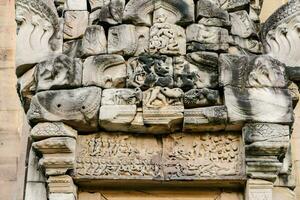 the carvings on the wall of the temple photo