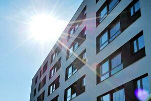 Brand new apartment building on sunny day. Modern residential architecture. Modern multi-family apartment house. photo